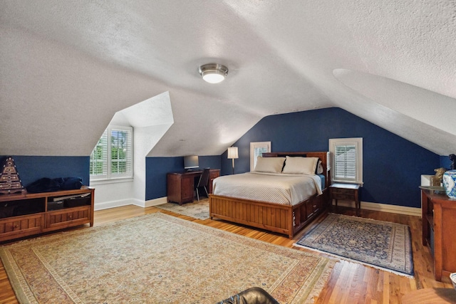 5231 Clinton Ave, Minneapolis, MN 55419 - bedroom featuring baseboards, a textured ceiling, vaulted ceiling, and wood finished floors
