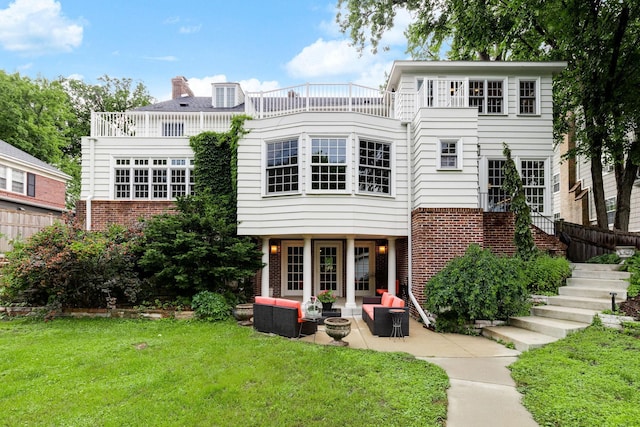 5231 Clinton Ave, Minneapolis, MN 55419 - back of house featuring stairs, brick siding, outdoor lounge area, a lawn, and a patio