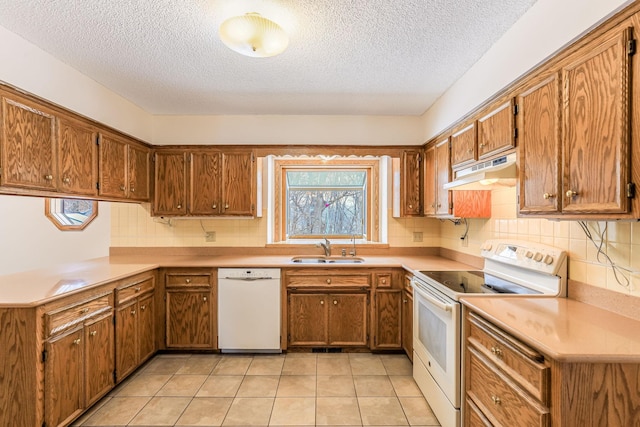 kitchen featuring sink, white appliances, light tile patterned floors, a textured ceiling, and decorative backsplash