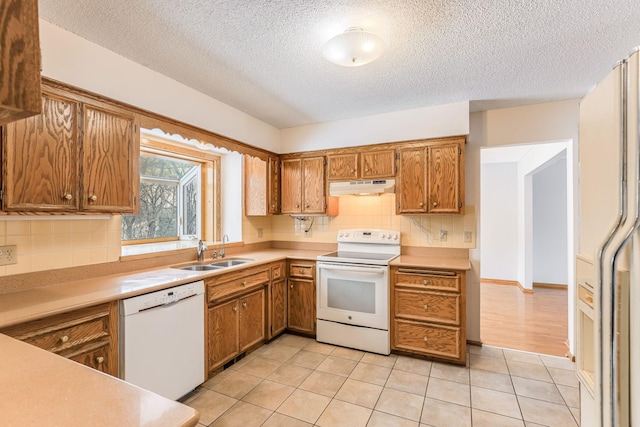 kitchen featuring sink, light tile patterned floors, white appliances, and decorative backsplash