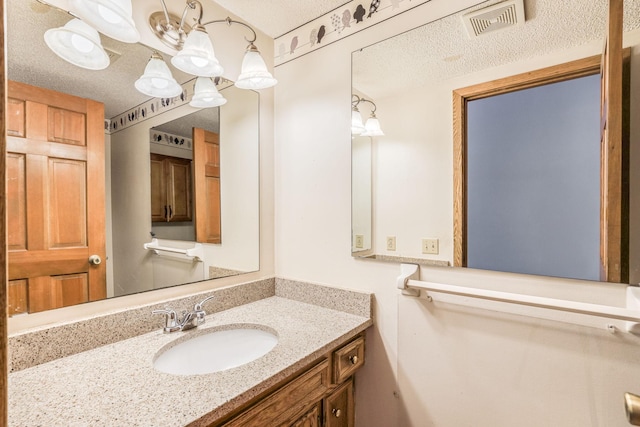 bathroom with vanity and a textured ceiling