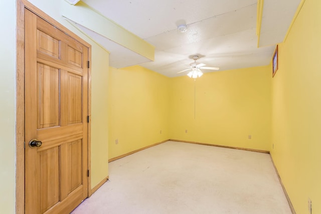 unfurnished room with ceiling fan and light carpet