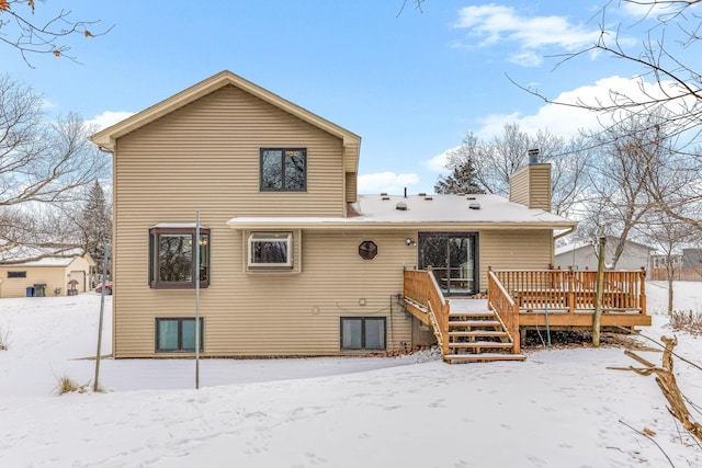 snow covered property featuring a wooden deck