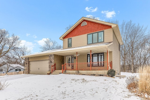 view of property with a garage and covered porch