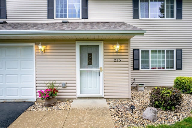 doorway to property with a garage