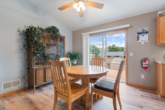 dining room featuring ceiling fan, lofted ceiling, and light hardwood / wood-style floors