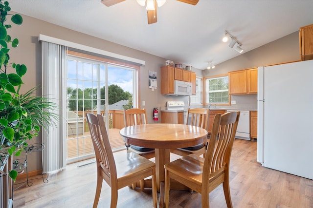 dining area with lofted ceiling, track lighting, ceiling fan, and light hardwood / wood-style flooring