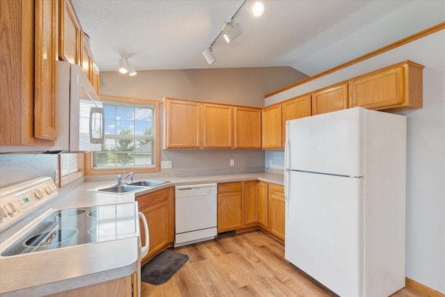 kitchen with light brown cabinetry, sink, vaulted ceiling, white appliances, and light hardwood / wood-style floors