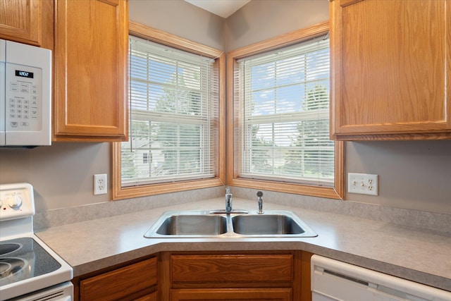 kitchen featuring sink and white appliances