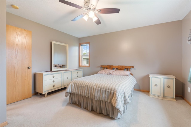 bedroom with light carpet and ceiling fan