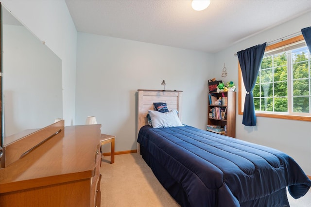 bedroom featuring light carpet