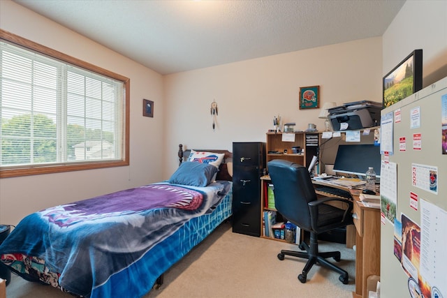 bedroom featuring carpet flooring and a textured ceiling