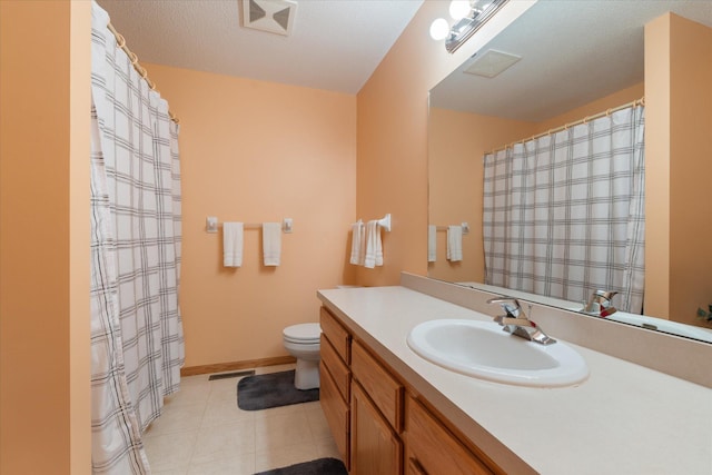 bathroom with tile patterned flooring, vanity, a textured ceiling, and toilet