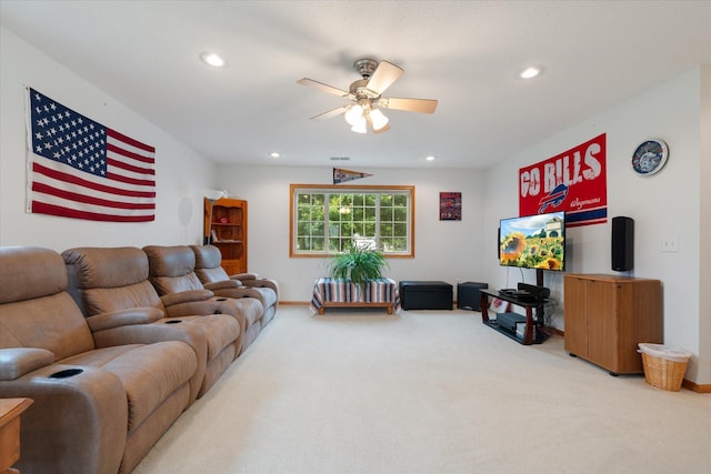 carpeted living room with ceiling fan