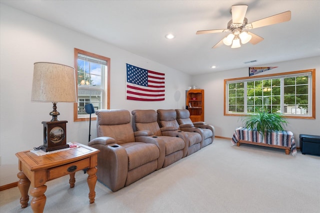 living room with ceiling fan and carpet