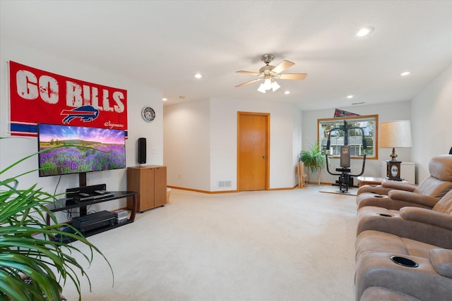 carpeted living room with ceiling fan