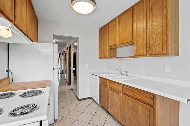 kitchen featuring range with electric stovetop, dishwasher, sink, and light tile patterned floors