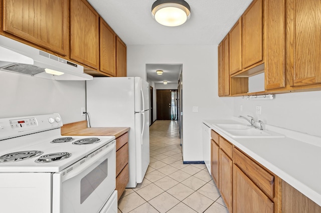 kitchen featuring sink, white appliances, and light tile patterned floors