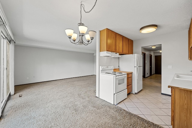 kitchen with sink, a chandelier, light tile patterned floors, white appliances, and a textured ceiling