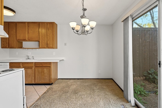 kitchen featuring sink, light tile patterned floors, hanging light fixtures, white range oven, and a notable chandelier