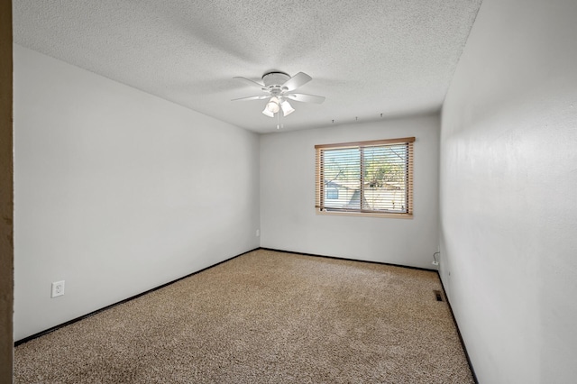 carpeted spare room with ceiling fan and a textured ceiling