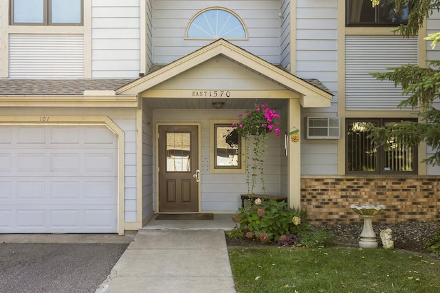 doorway to property with a garage