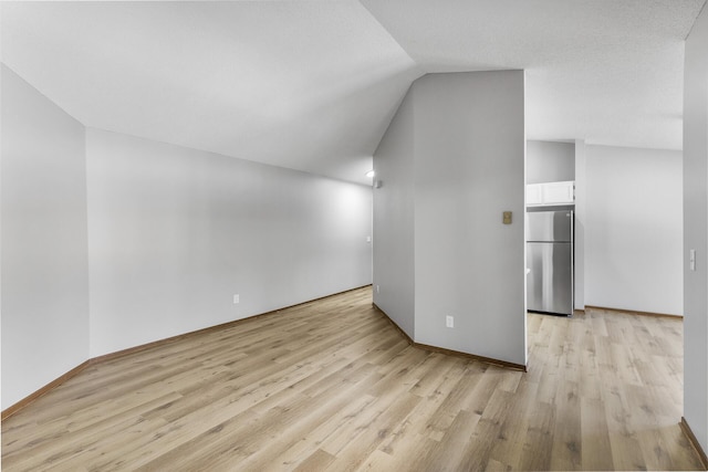 bonus room with vaulted ceiling and light hardwood / wood-style floors