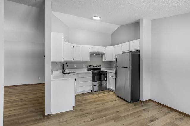 kitchen with lofted ceiling, sink, white cabinetry, light hardwood / wood-style flooring, and appliances with stainless steel finishes