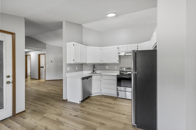 kitchen with stainless steel appliances, sink, light hardwood / wood-style flooring, and white cabinets