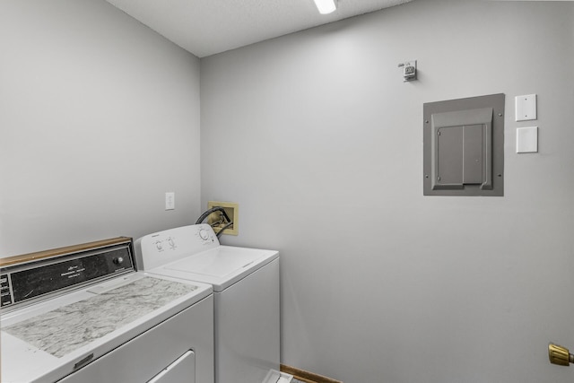 laundry room with washing machine and clothes dryer and electric panel