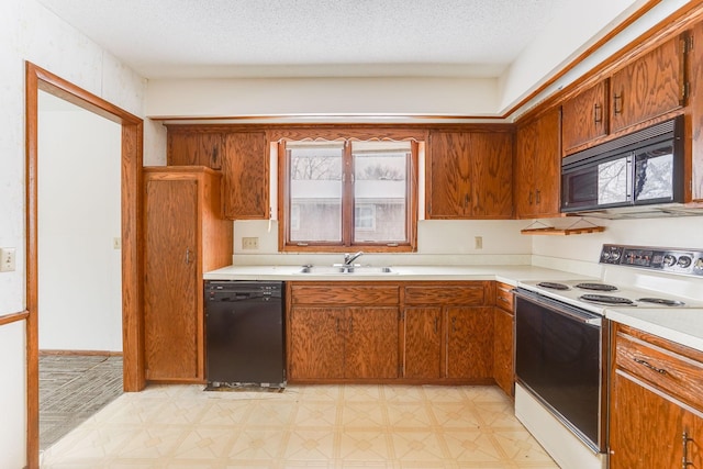 kitchen featuring sink, plenty of natural light, black appliances, and a textured ceiling