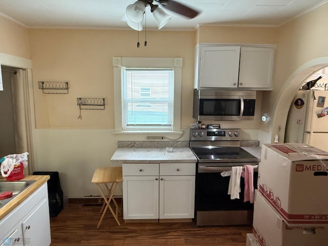 kitchen featuring white cabinetry, stainless steel appliances, and dark wood-type flooring