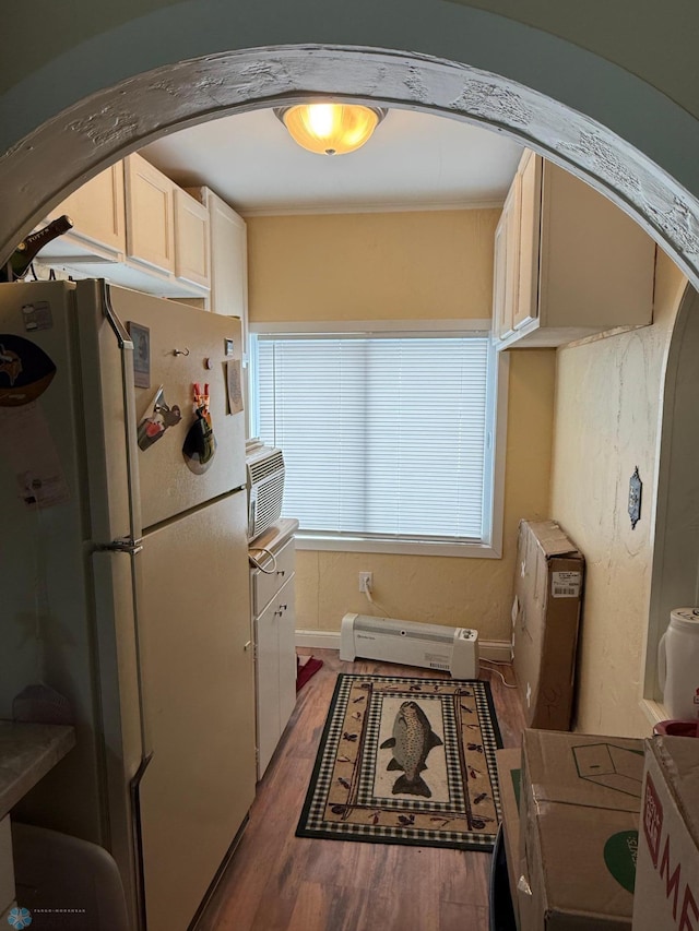 kitchen featuring white refrigerator, a baseboard radiator, and dark wood-type flooring