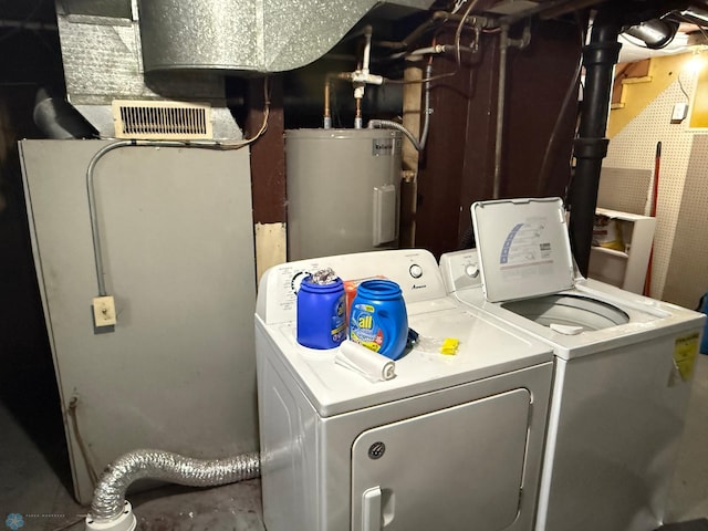 washroom with washing machine and dryer and electric water heater