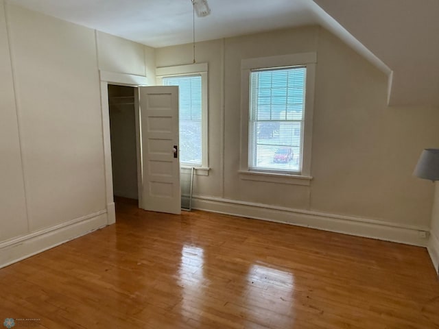 additional living space with light hardwood / wood-style flooring