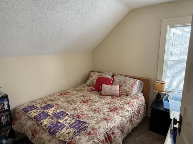 carpeted bedroom featuring vaulted ceiling and a textured ceiling