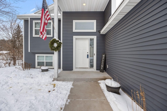 view of snow covered property entrance