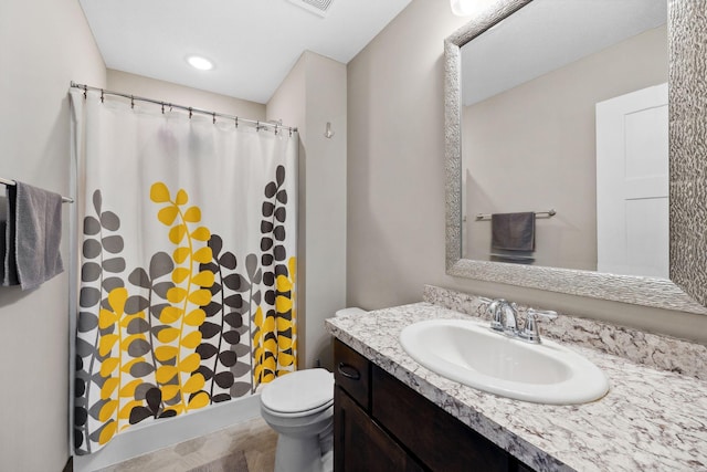 bathroom with a shower with curtain, vanity, and toilet