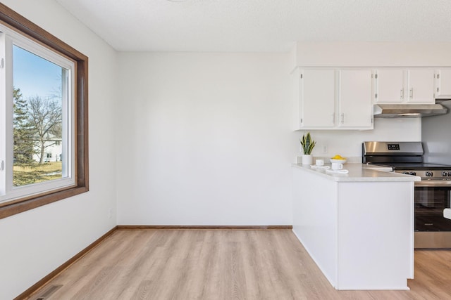 kitchen featuring under cabinet range hood, baseboards, stainless steel range with electric stovetop, and light wood-style flooring