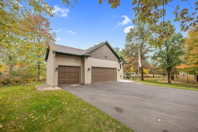 view of property exterior with a yard and a garage