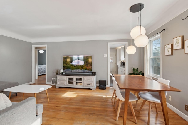 dining space with light wood-type flooring