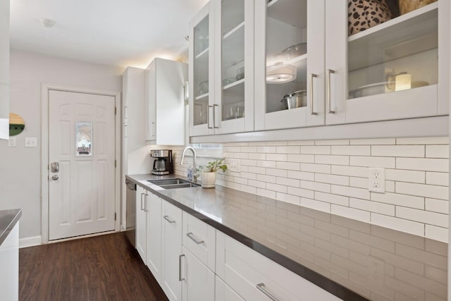 kitchen featuring sink, white cabinetry, tasteful backsplash, dark hardwood / wood-style flooring, and dishwasher