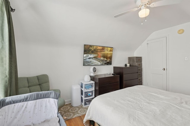 bedroom featuring hardwood / wood-style flooring, ceiling fan, and lofted ceiling