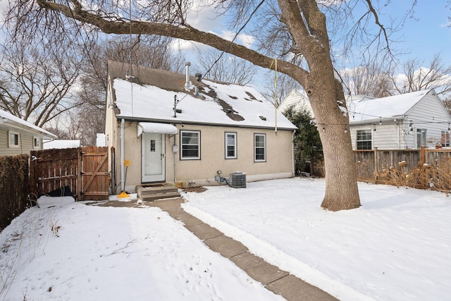 snow covered house with cooling unit