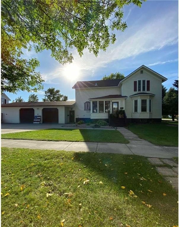 view of front of property with a garage and a front lawn