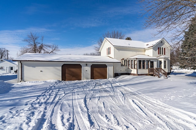 view of front of house with a garage and a sunroom