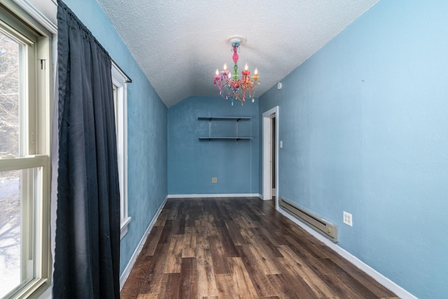 109 3rd St E, Ada, MN 56510 - empty room featuring baseboard heating, dark wood-type flooring, vaulted ceiling, a textured ceiling, and a chandelier