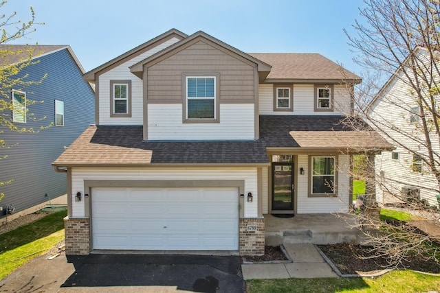 6789 Troy Ln N, Maple Grove, MN 55311 - view of front of house with asphalt driveway, a shingled roof, an attached garage, and brick siding
