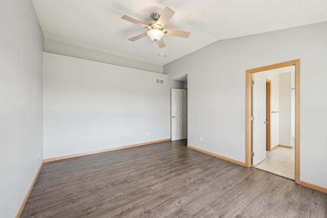6789 Troy Ln N, Maple Grove, MN 55311 - spare room with ceiling fan, wood finished floors, lofted ceiling, and baseboards