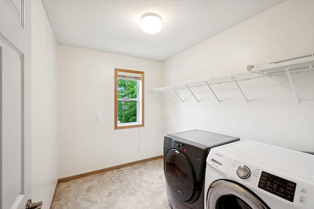 6789 Troy Ln N, Maple Grove, MN 55311 - washroom with independent washer and dryer, a textured ceiling, and baseboards
